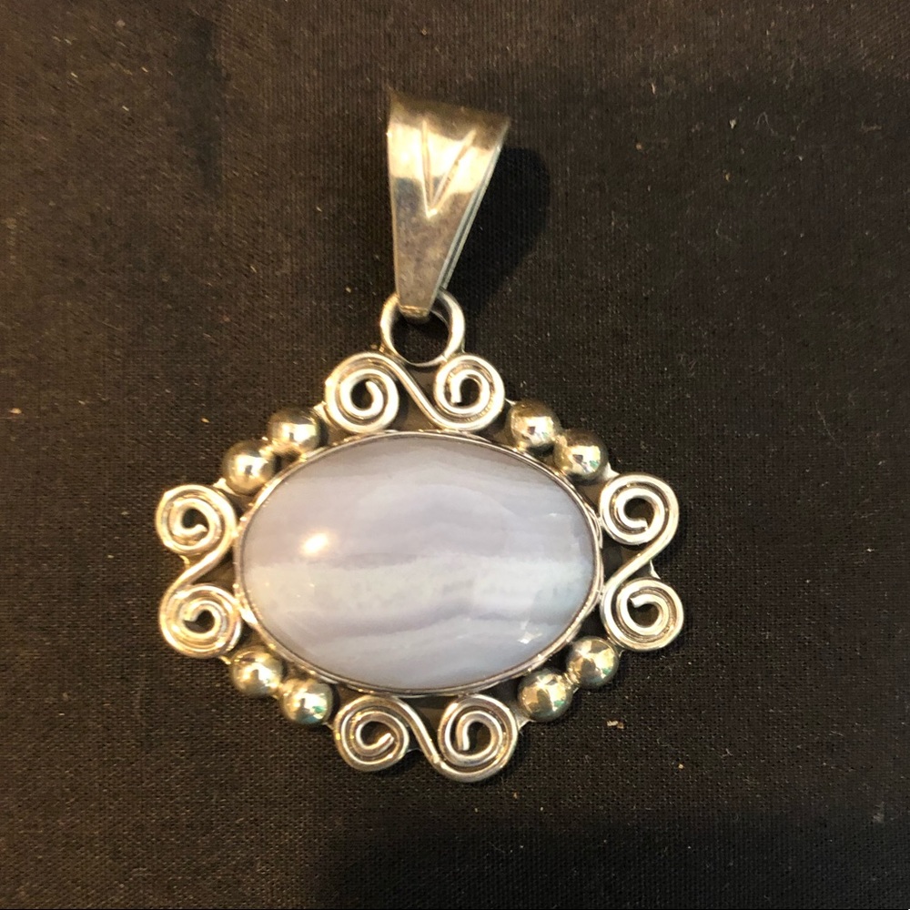 Silver pendant with a purple/grey stone